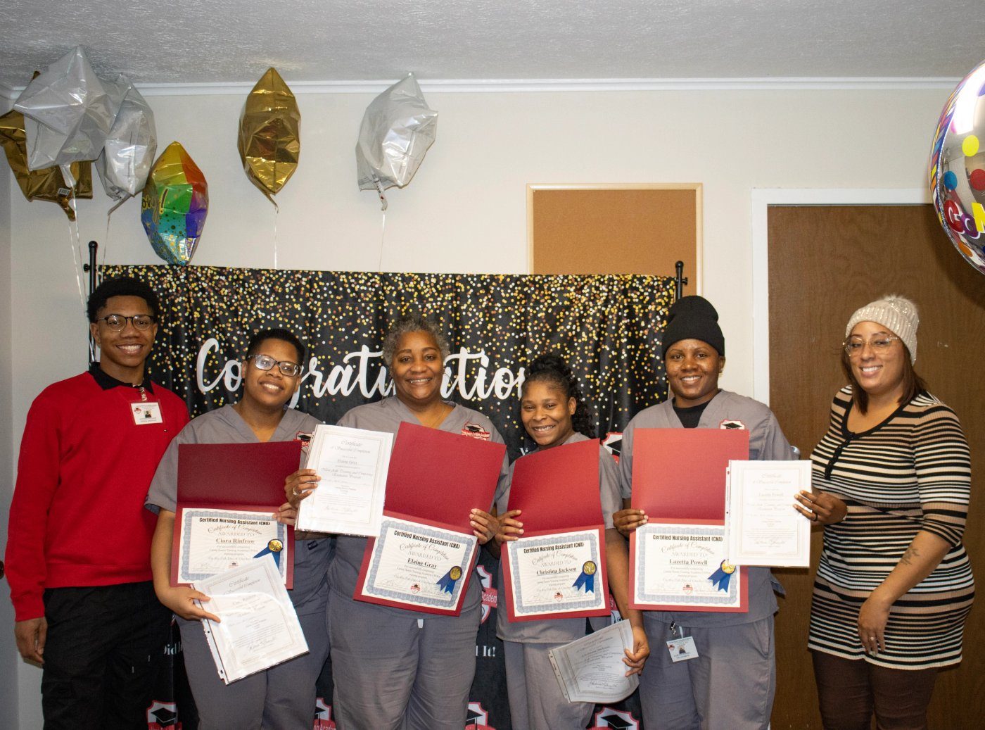 Graduates holding their certificates of completion
